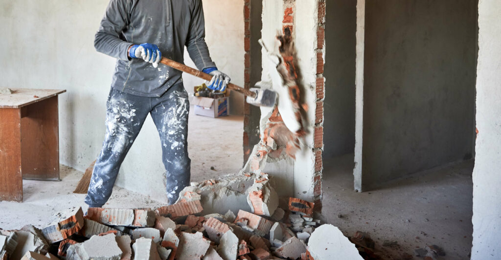 sledge hammer being used at demolition site